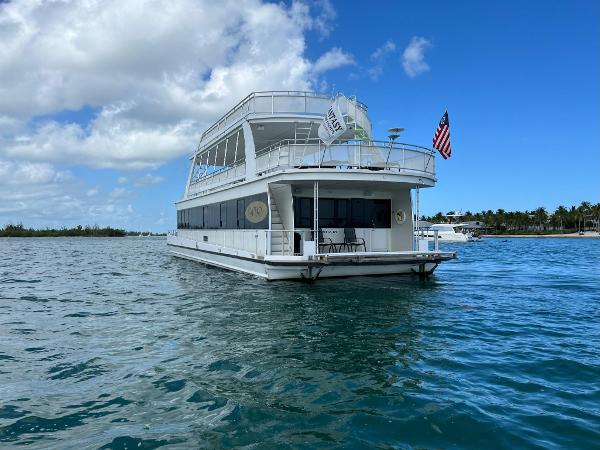 Slide: The Image of White 2009 Fantasy Houseboat on calm blue water under a partly cloudy sky. - 5