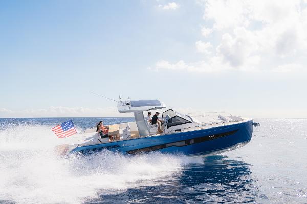 Slide: The Image of 2025 Fiart 43 Seawalker yacht cruising on open water with American flag. - 1