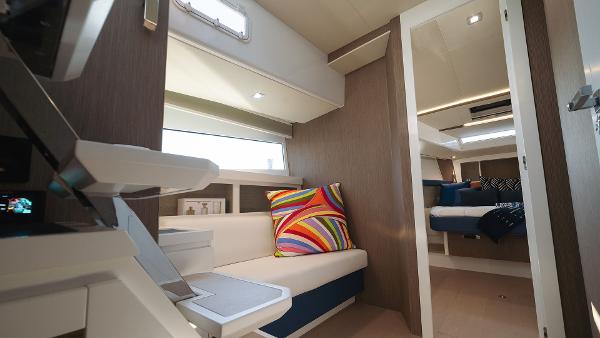 Slide: The Image of Interior of 2025 Fiart 43 Seawalker yacht with modern seating and colorful pillow. - 7