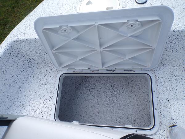 Slide: The Image of Open storage compartment on a 2023 Fibercraft 160 Pro Vee boat. - 12