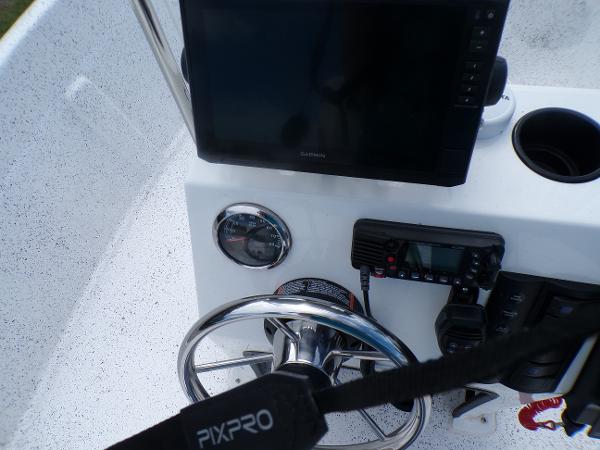 Slide: The Image of Fibercraft 160 Pro Vee 2023 boat dashboard with steering wheel and electronic controls. - 7