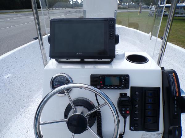 Slide: The Image of Fibercraft 160 Pro Vee 2023 boat console with steering wheel, GPS, and control panel. - 8