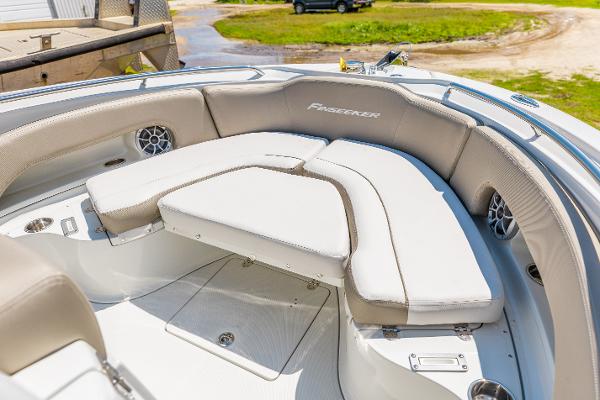 Slide: The Image of 2024 Finseeker 230 CC boat with cushioned seating and storage compartments. - 17