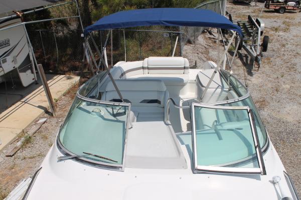 Slide: The Image of 2001 Formula 260 Sun Sport boat with blue canopy and open windshield, parked on gravel. - 10