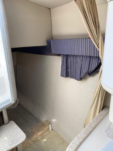 Slide: The Image of 2003 Formula 27 PC cabin interior with striped curtains and beige walls. - 3