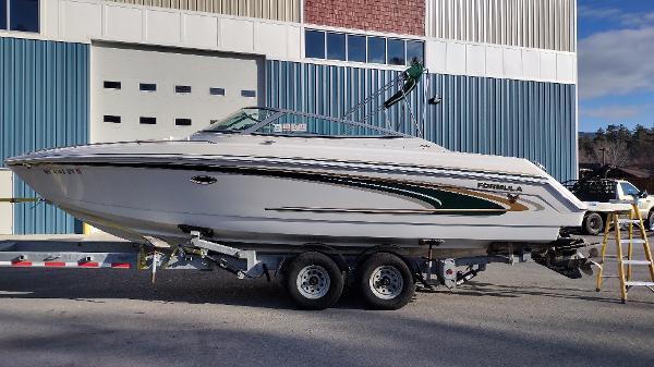 Slide: The Image of 2004 Formula 280 Sun Sport boat on a trailer outside a warehouse. - 0