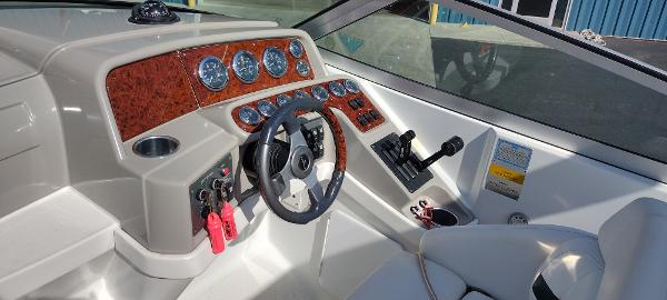 Slide: The Image of 2004 Formula 280 Sun Sport boat dashboard with steering wheel and control panel. - 10