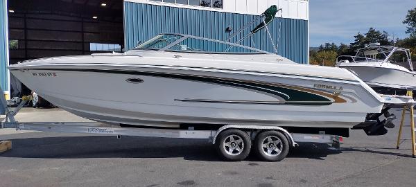 Slide: The Image of 2004 Formula 280 Sun Sport boat on a trailer outside a blue building. - 2
