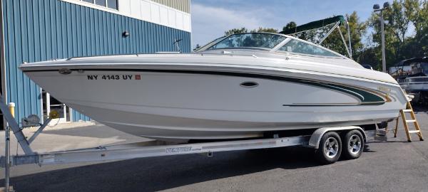 Slide: The Image of 2004 Formula 280 Sun Sport boat on a trailer outside a blue building. - 3