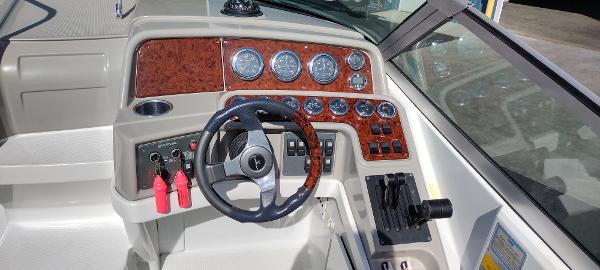 Slide: The Image of 2004 Formula 280 Sun Sport boat dashboard with steering wheel and control panel. - 9