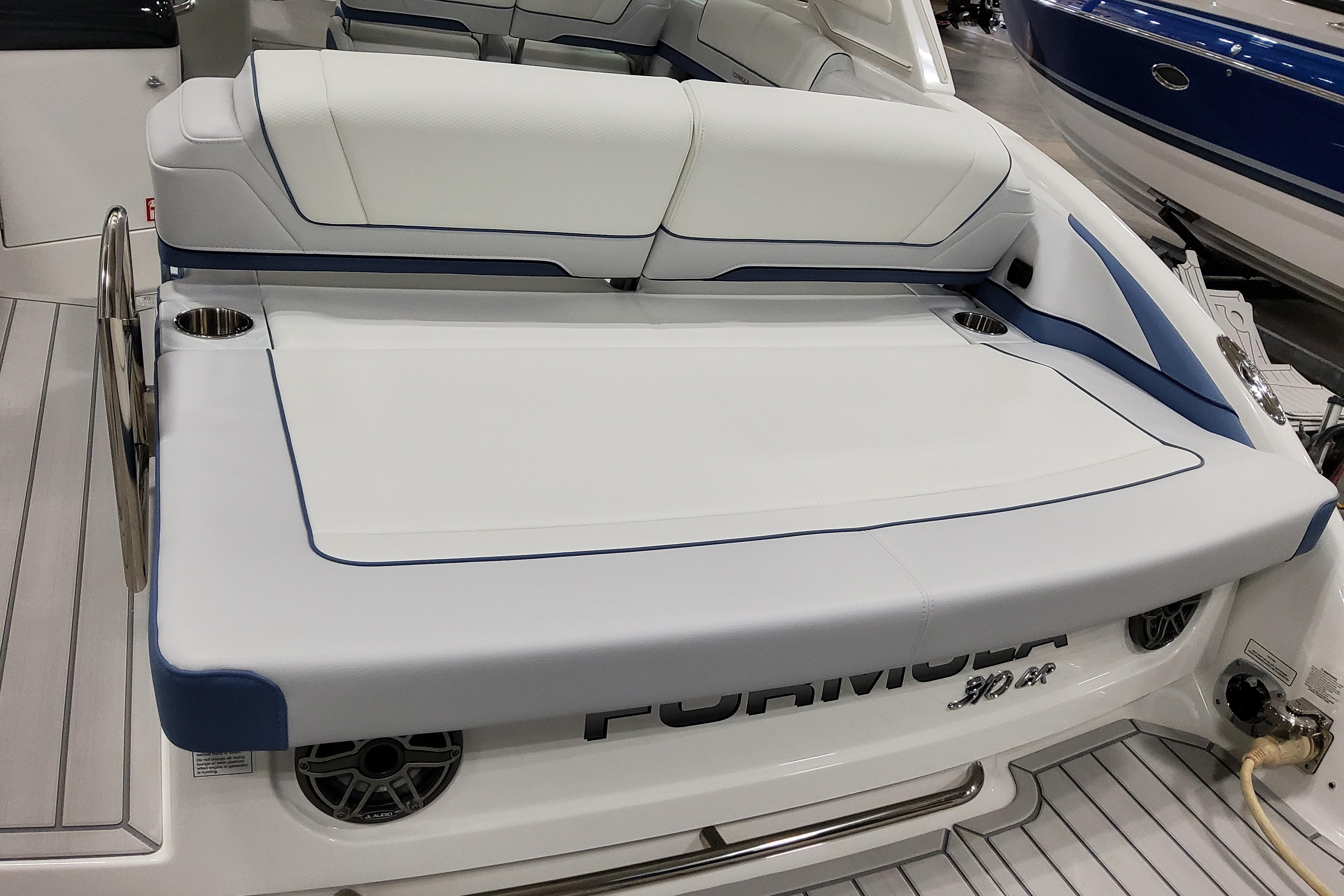 Slide: The Image of 2026 Formula 310 Bowrider OB boat interior with white and blue seating. - 10