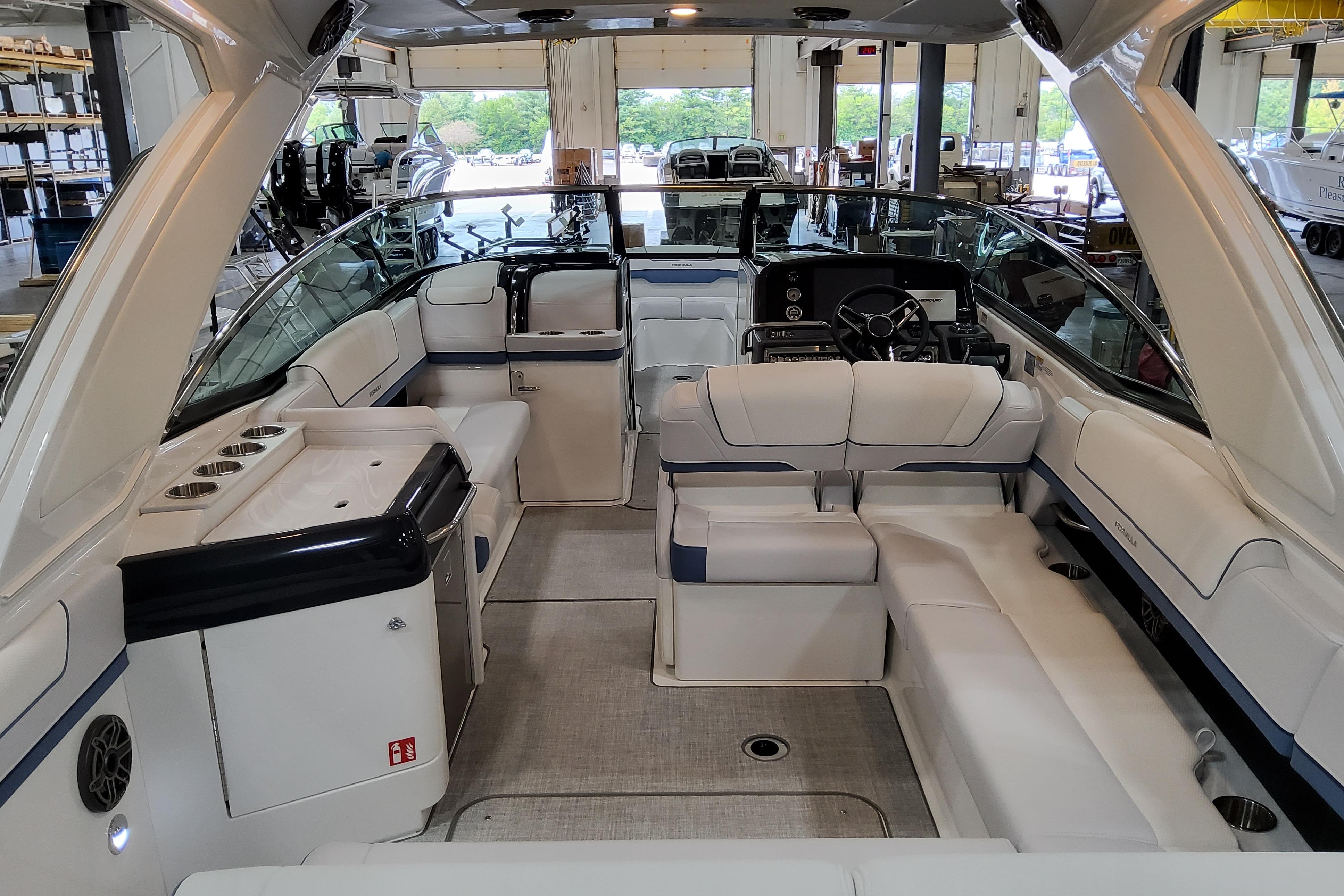 Slide: The Image of 2026 Formula 310 Bowrider OB interior with luxurious seating and modern helm in a showroom. - 11