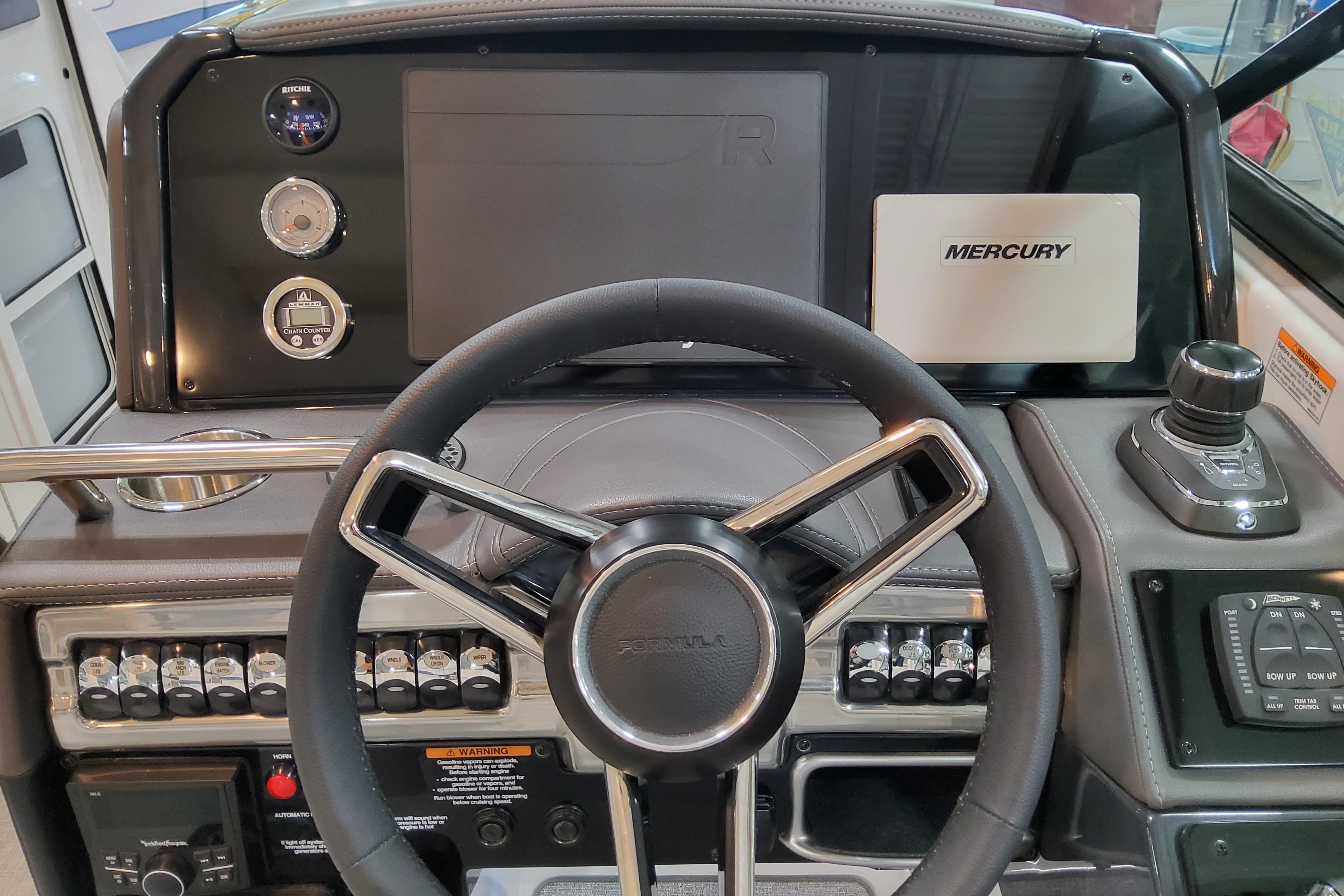 Slide: The Image of 2026 Formula 310 Bowrider OB dashboard with steering wheel and Mercury controls. - 17