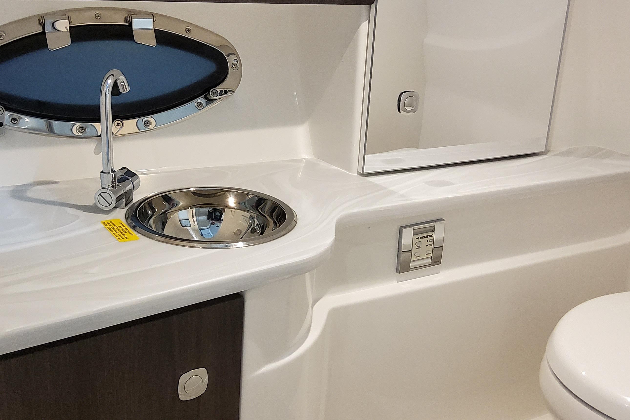 Slide: The Image of 2026 Formula 310 Bowrider OB bathroom with sink, faucet, and oval window. - 18