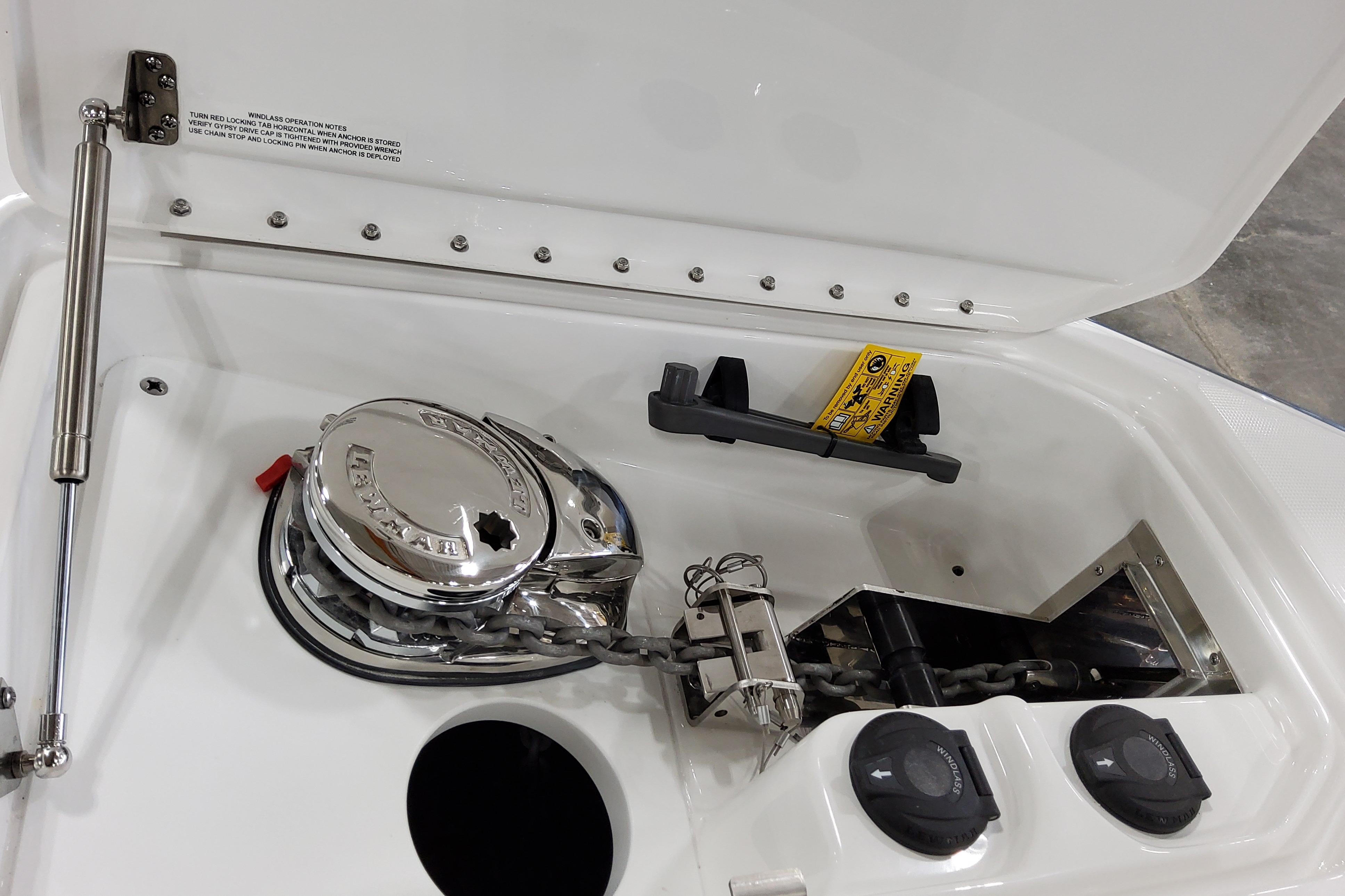 Slide: The Image of 2026 Formula 310 Bowrider OB anchor compartment with winch and chain storage. - 21