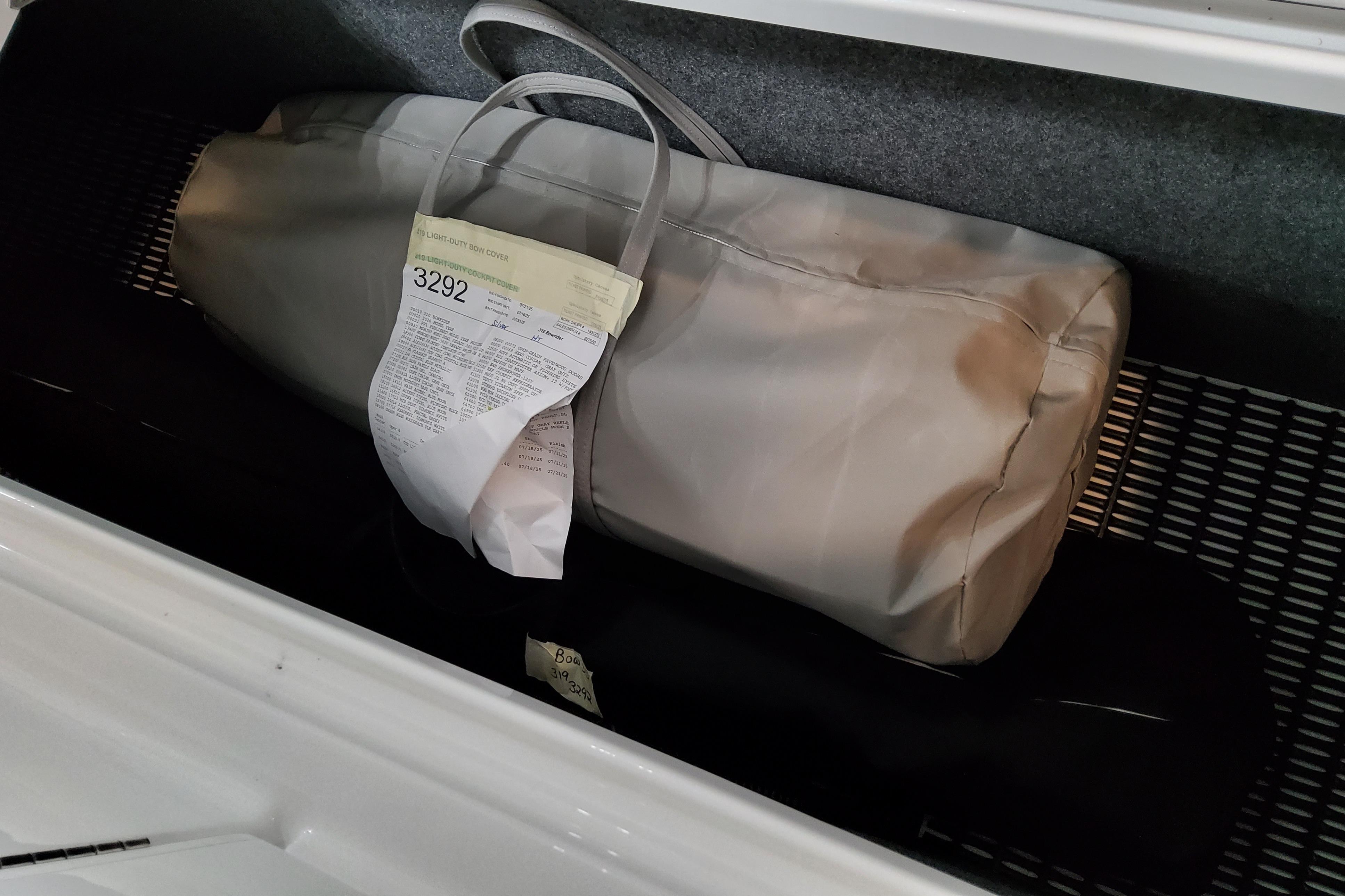 Slide: The Image of Storage compartment of 2026 Formula 310 Bowrider OB with bag and paperwork. - 22