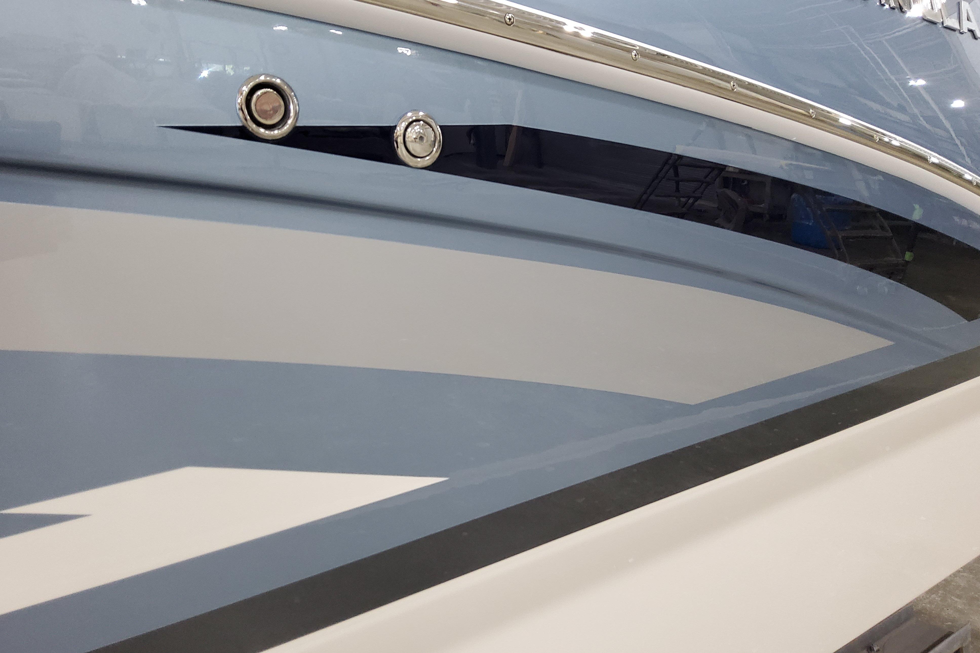 Slide: The Image of 2026 Formula 310 Bowrider OB boat hull with sleek blue and white design. - 3