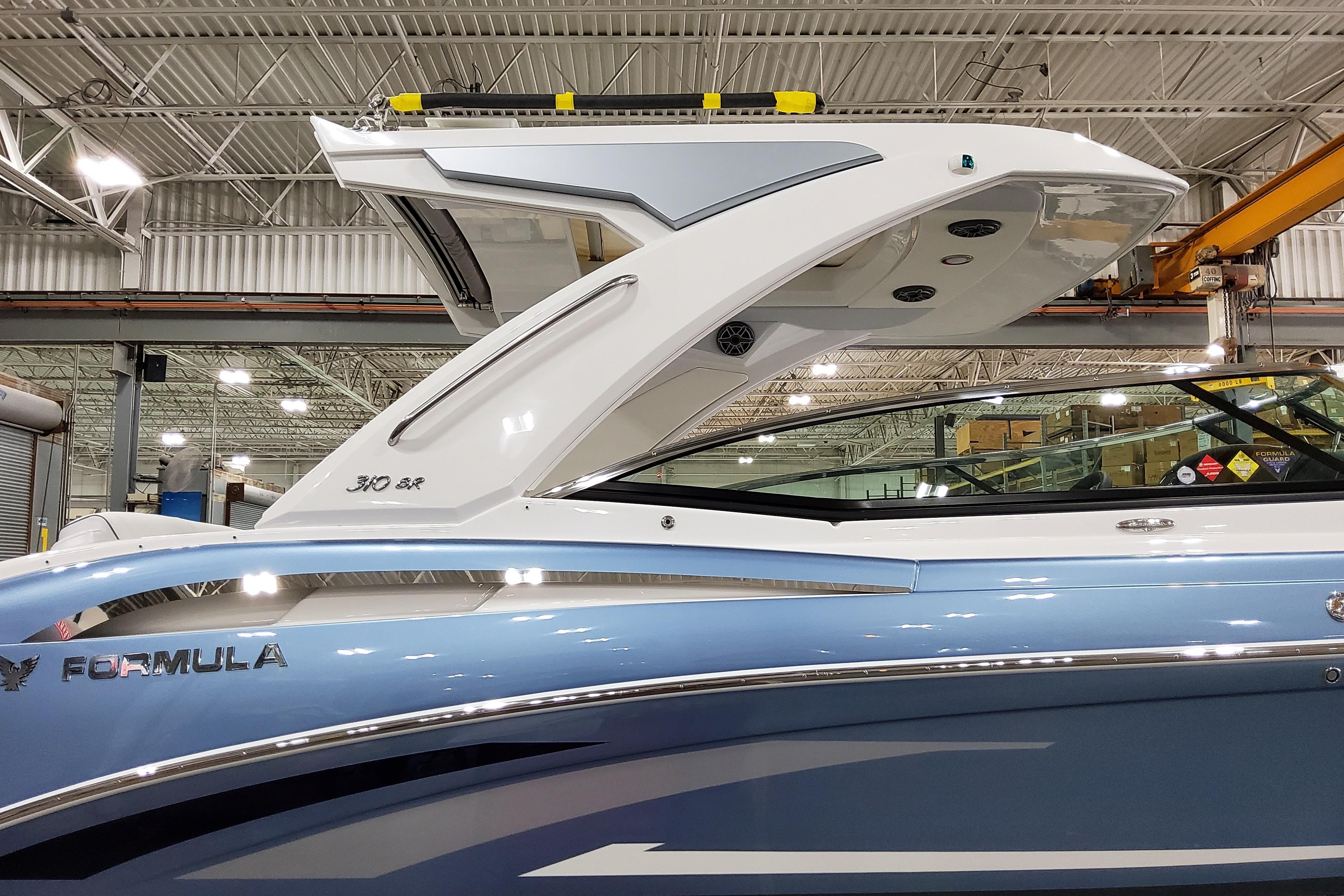 Slide: The Image of 2026 Formula 310 Bowrider OB in a showroom, showcasing sleek design and modern features. - 4