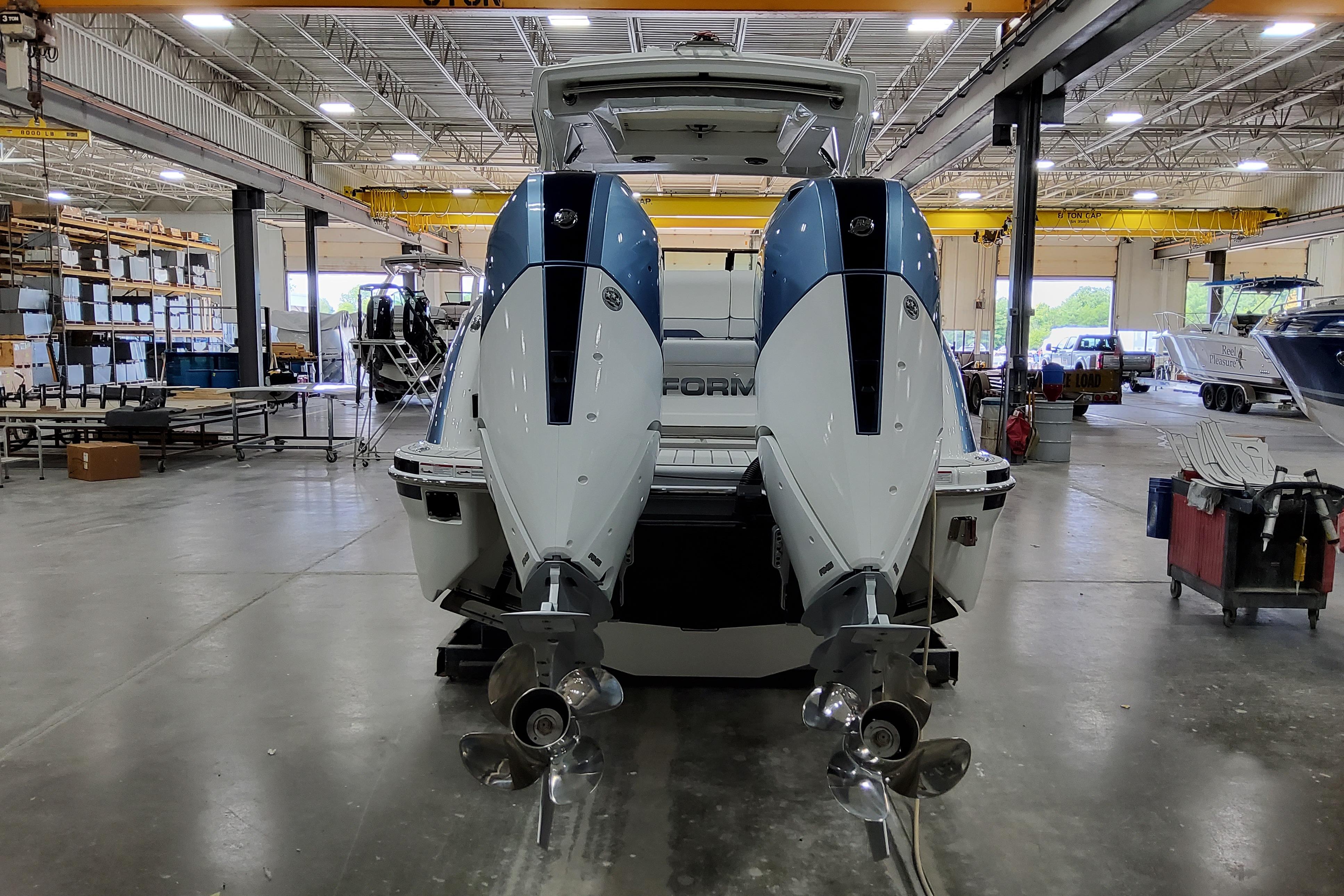 Slide: The Image of 2026 Formula 310 Bowrider OB in a spacious boat manufacturing facility. - 5