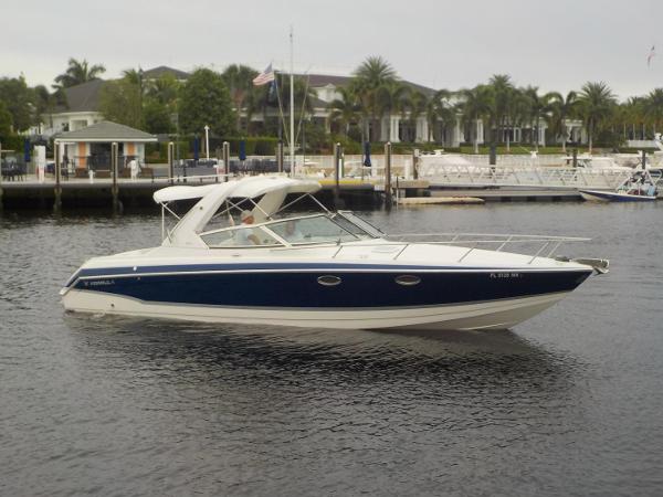 Slide: The Image of 2006 Formula 330 SS boat on calm water near a marina. - 0
