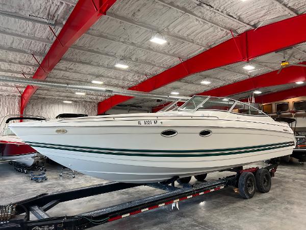 Slide: The Image of 1999 Formula 330 SS Sun Sport boat on trailer in indoor storage facility. - 0