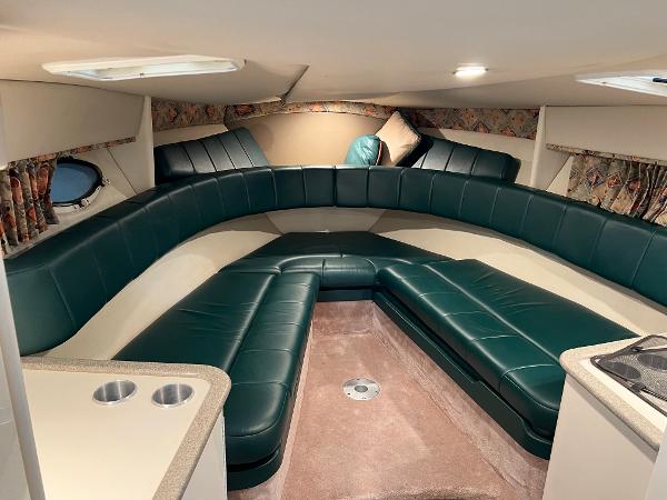 Slide: The Image of Interior of a 1999 Formula 330 SS Sun Sport boat with green leather seating. - 10