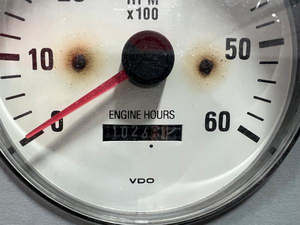 Slide: The Image of Close-up of 1999 Formula 330 SS Sun Sport engine hours gauge showing 1026 hours. - 11