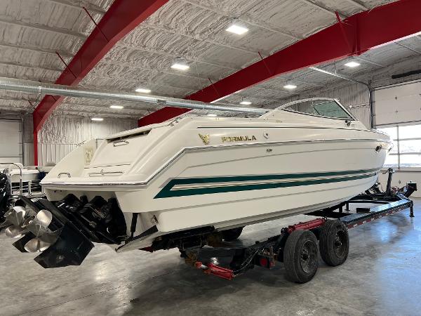 Slide: The Image of 1999 Formula 330 SS Sun Sport boat on trailer in indoor storage facility. - 2