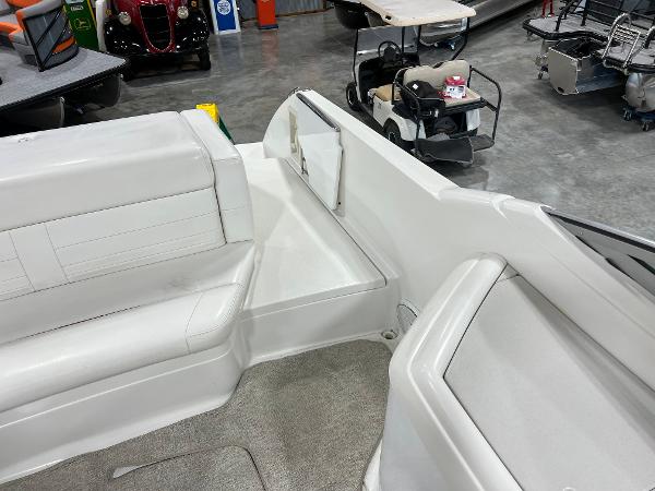 Slide: The Image of 1999 Formula 330 SS Sun Sport boat interior with white seating and storage compartments. - 6