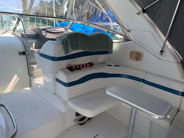Slide: The Image of 2005 Formula 34 PC boat interior with white and blue seating and small table. - 42