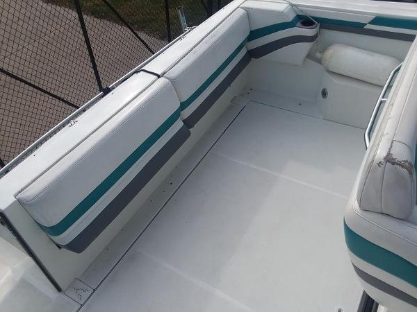 Slide: The Image of 1990 Formula 36 PC boat interior with white and teal seating. - 12