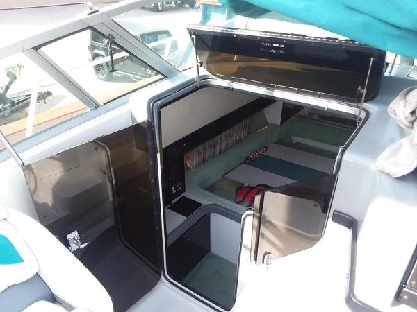 Slide: The Image of 1990 Formula 36 PC boat interior with open cabin door and seating area. - 15