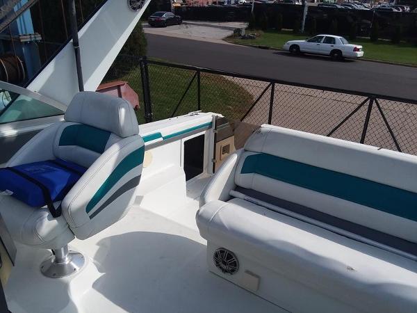 Slide: The Image of 1990 Formula 36 PC boat interior with white and teal seating. - 17