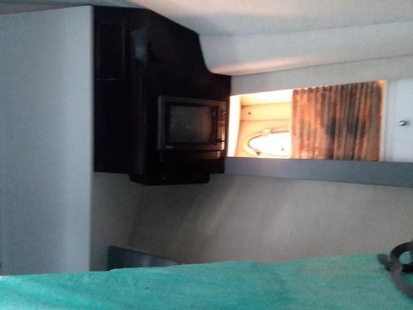 Slide: The Image of Interior cabin of a 1990 Formula 36 PC boat with microwave and porthole. - 2