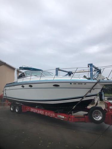 Slide: The Image of 1990 Formula 36 PC boat on a trailer at a marina. - 3