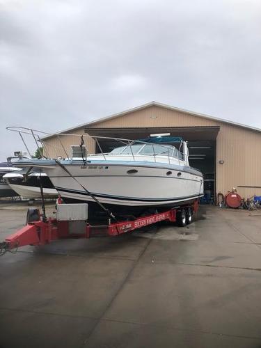 Slide: The Image of 1990 Formula 36 PC boat on a trailer outside a storage facility. - 5