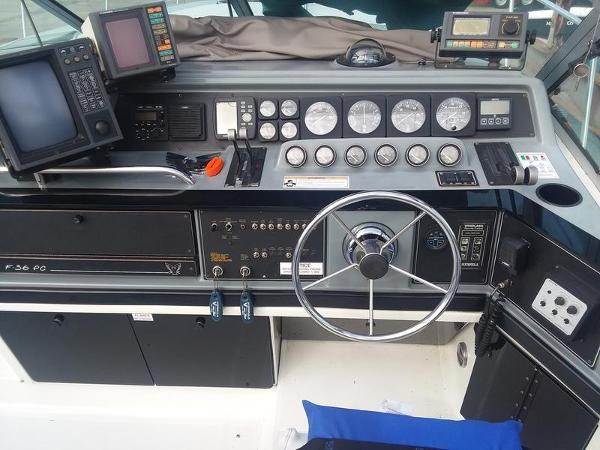 Slide: The Image of 1990 Formula 36 PC boat dashboard with steering wheel, gauges, and navigation equipment. - 8