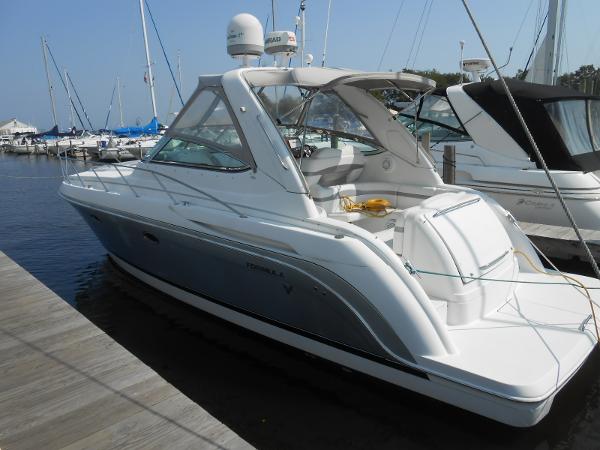 Slide: The Image of 2004 Formula 37 PC yacht docked at marina, featuring sleek design and spacious deck. - 0
