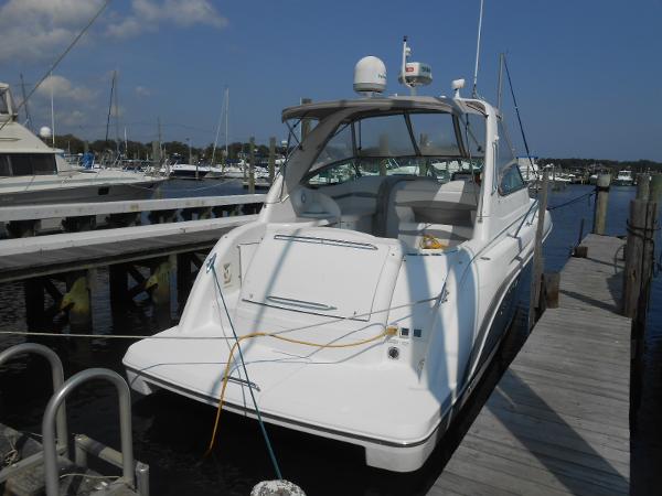 Slide: The Image of 2004 Formula 37 PC yacht docked at a marina under a clear blue sky. - 2