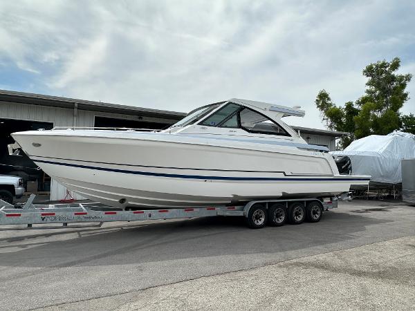 Slide: The Image of 2021 Formula 380 SSC boat on a trailer in a marina. - 0