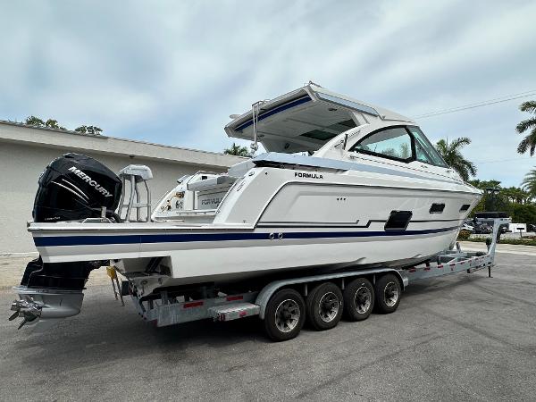 Slide: The Image of 2021 Formula 380 SSC boat on a trailer with Mercury outboard engines. - 2