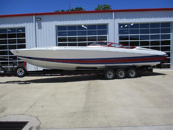 Slide: The Image of 1997 Formula 382 FASTech speedboat on a trailer outside a garage. - 1