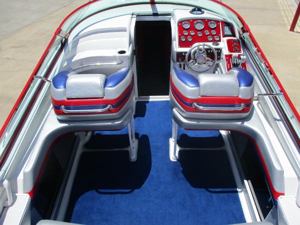 Slide: The Image of 1997 Formula 382 FASTech boat interior with blue carpet and red, white, and blue seats. - 10
