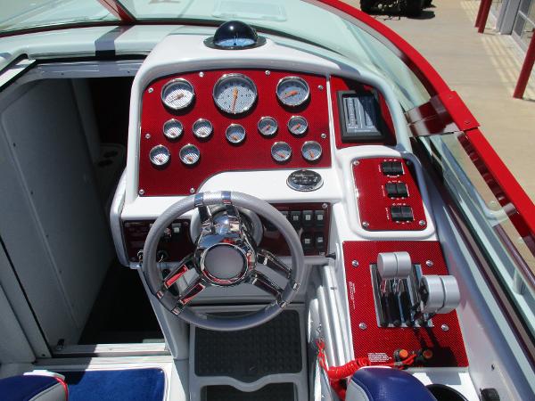 Slide: The Image of 1997 Formula 382 FASTech boat dashboard with red accents and multiple gauges. - 11