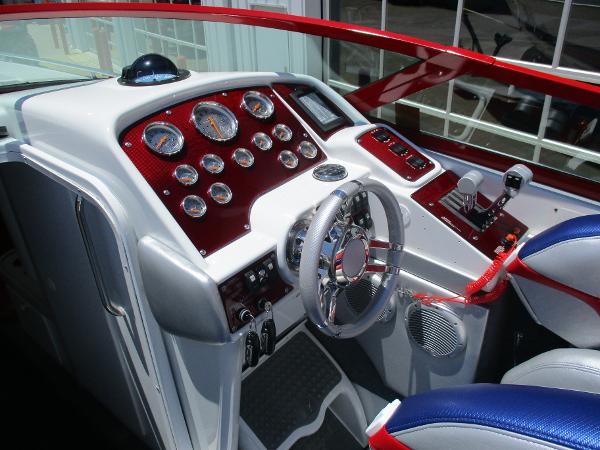 Slide: The Image of 1997 Formula 382 FASTech boat cockpit with red and white dashboard and steering wheel. - 12