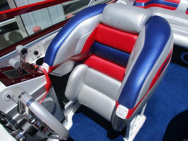Slide: The Image of 1997 Formula 382 FASTech boat cockpit with red, blue, and gray seating. - 13