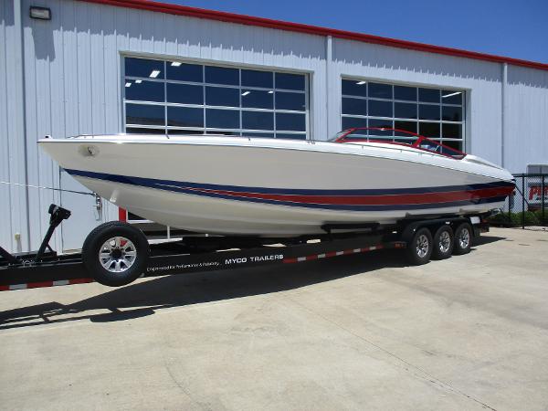 Slide: The Image of 1997 Formula 382 FASTech boat on a trailer outside a garage. - 2