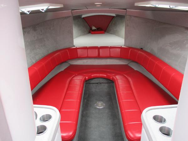 Slide: The Image of 1997 Formula 382 FASTech boat interior with red seating and cup holders. - 22