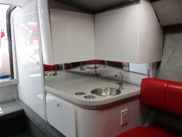 Slide: The Image of 1997 Formula 382 FASTech boat interior kitchenette with sink and storage cabinets. - 26