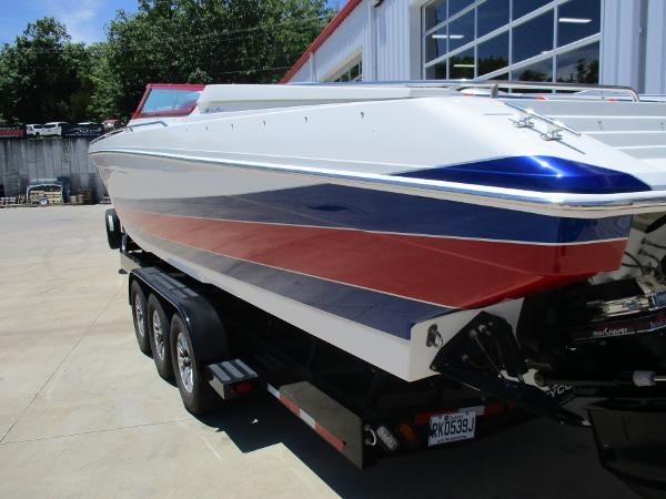 Slide: The Image of 1997 Formula 382 FASTech boat with red, white, and blue stripes on a trailer. - 5